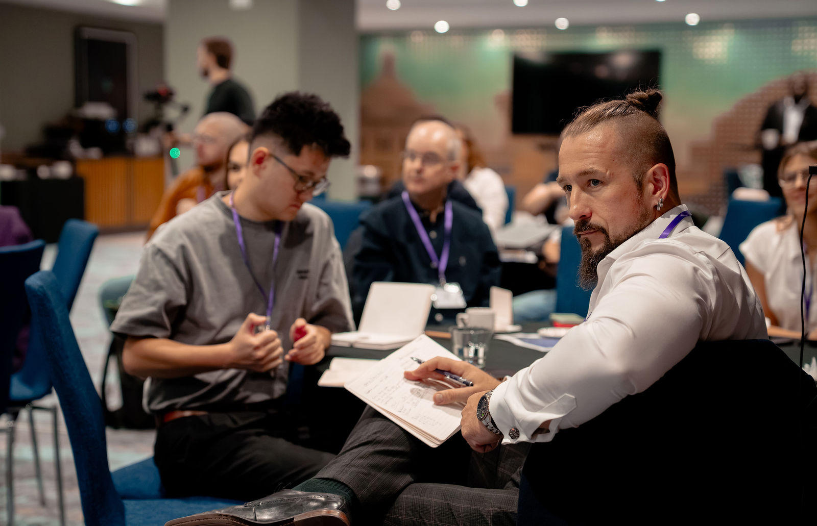 Delegates exchanging ideas during a table discussion.