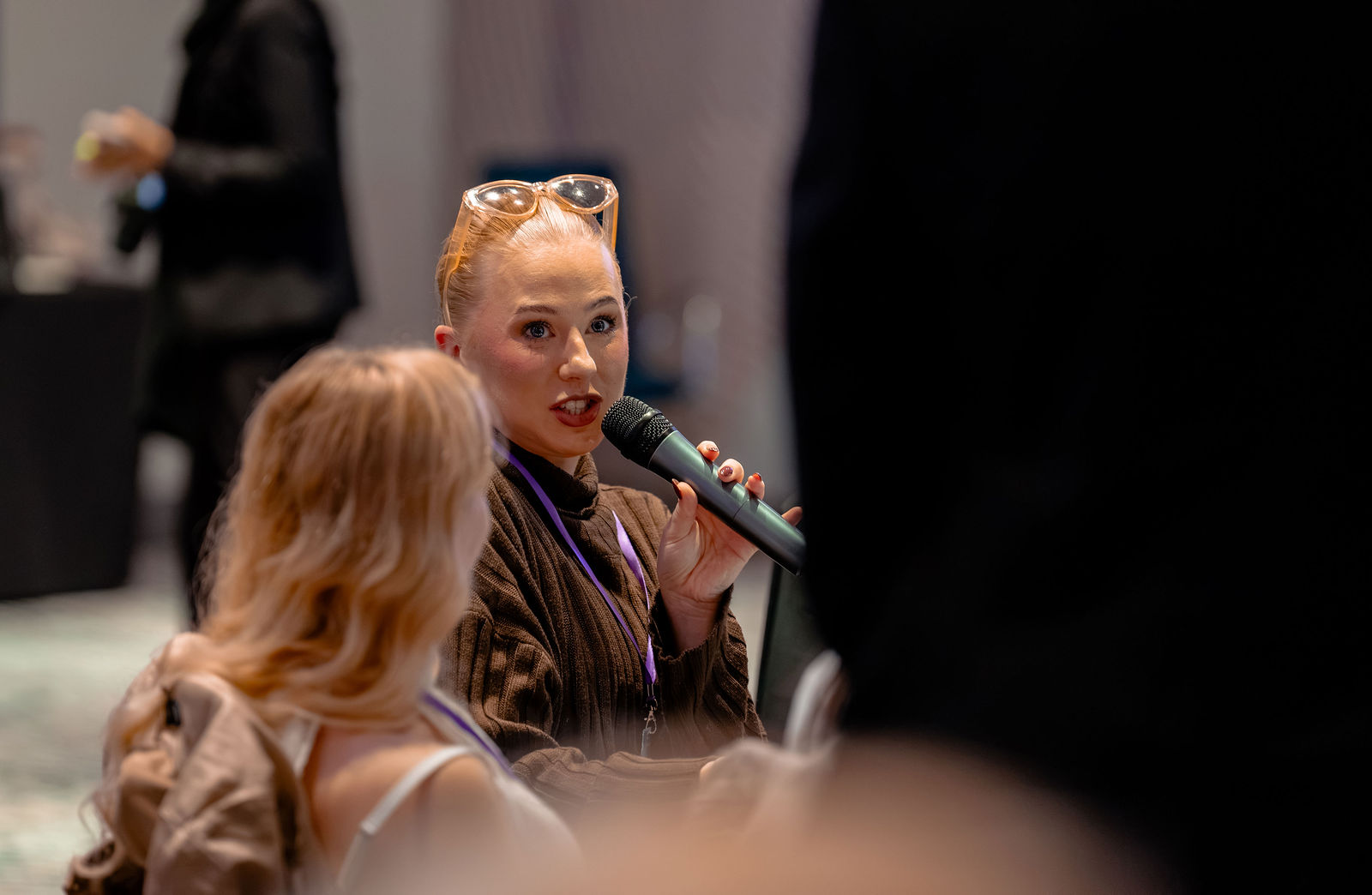 A participant contributing to the discussion with a microphone.