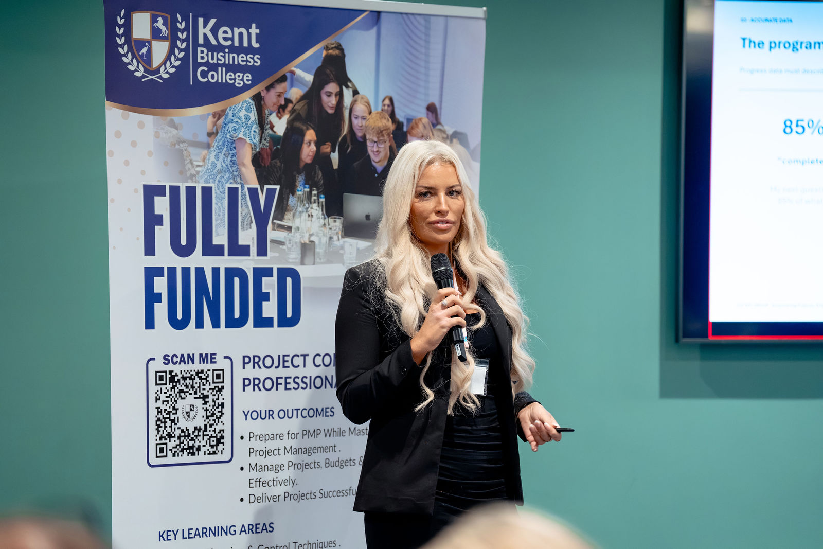A speaker leading a workshop conversation.